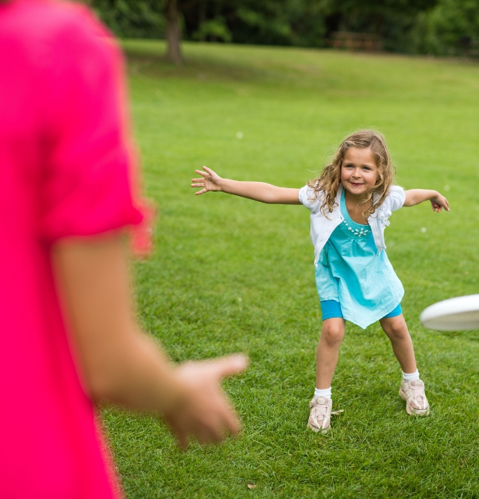 A child throws a frisbee.