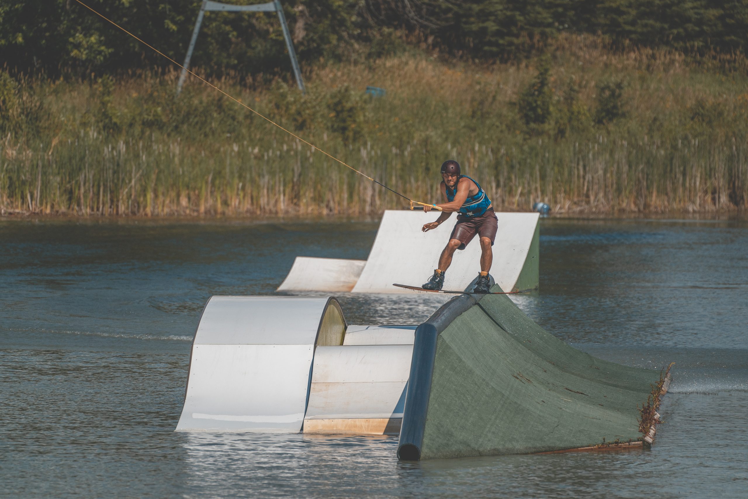 Man waterboarding at Planet Bayou with obstacles