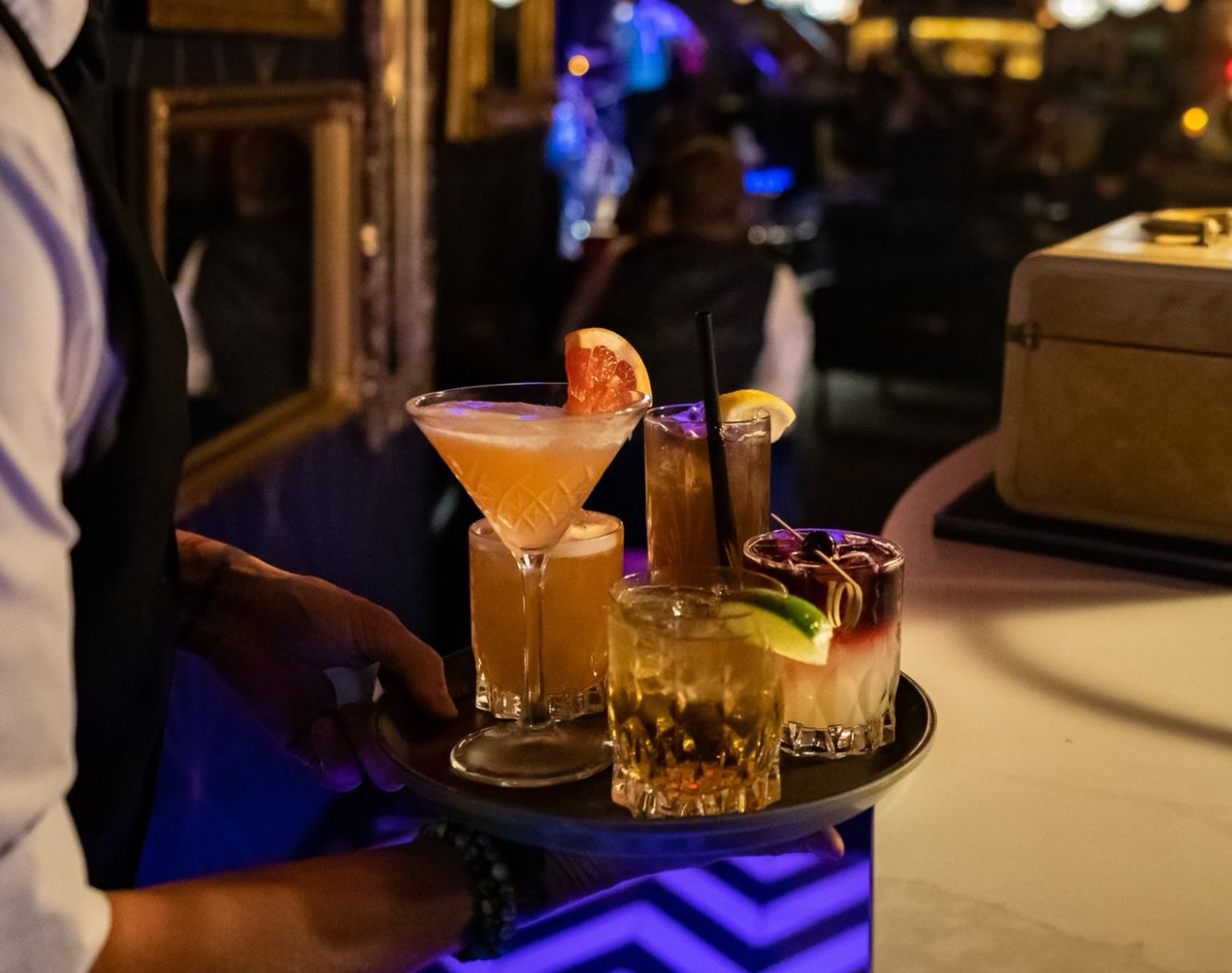 waiter holding a tray of drinks