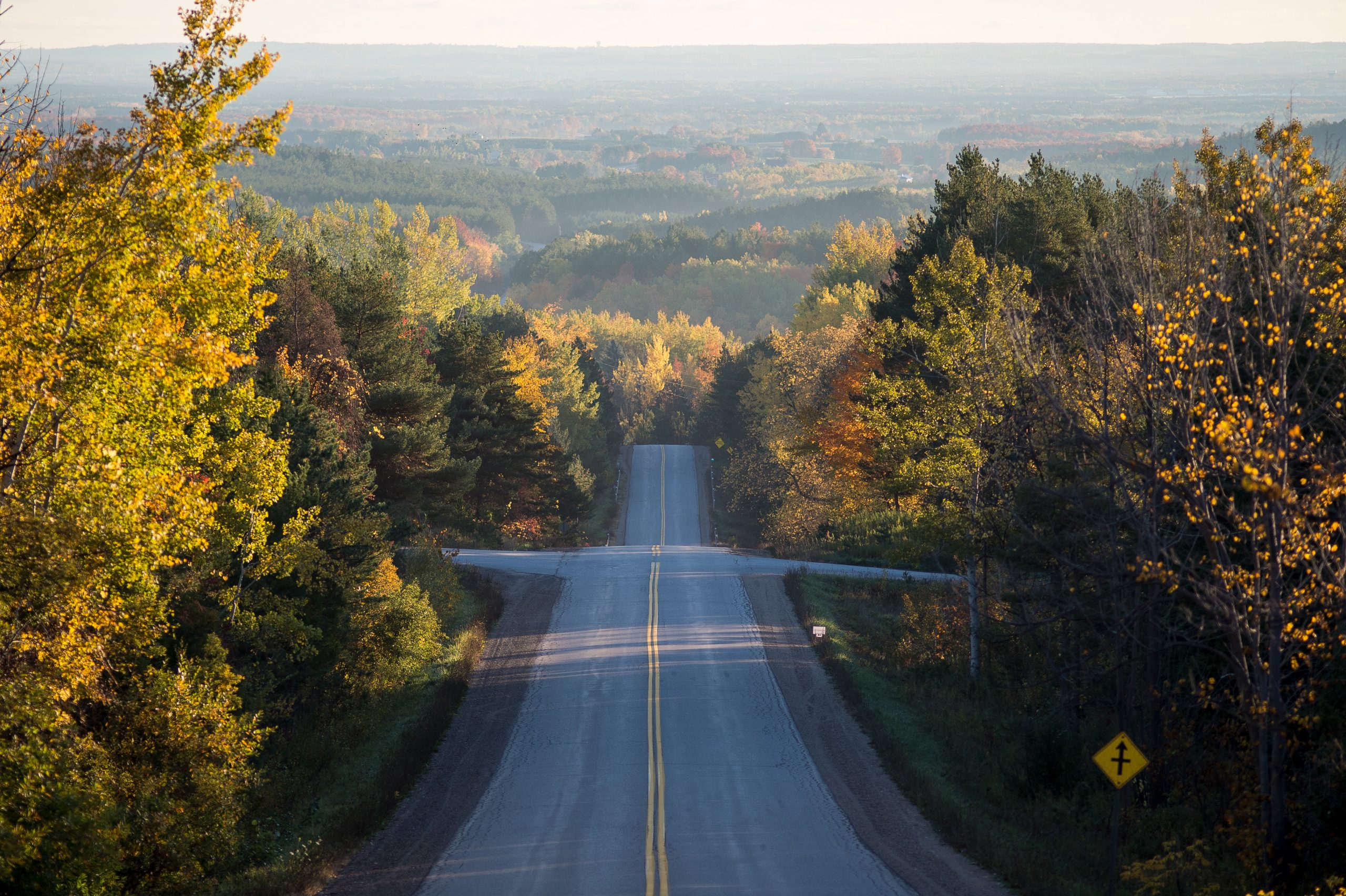 An intersection surrounded by forests.