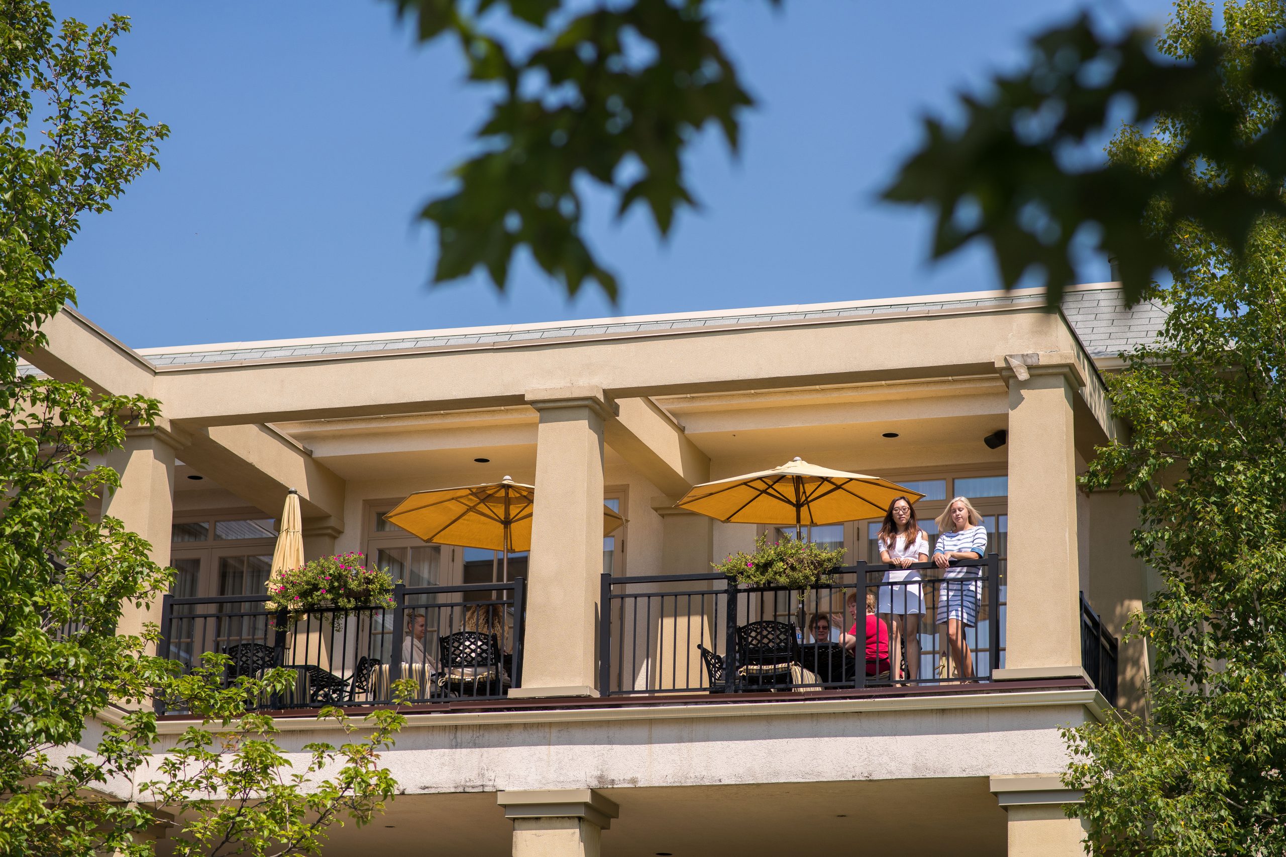 Two guests stand on a balcony at the Hockley Valley Resort.