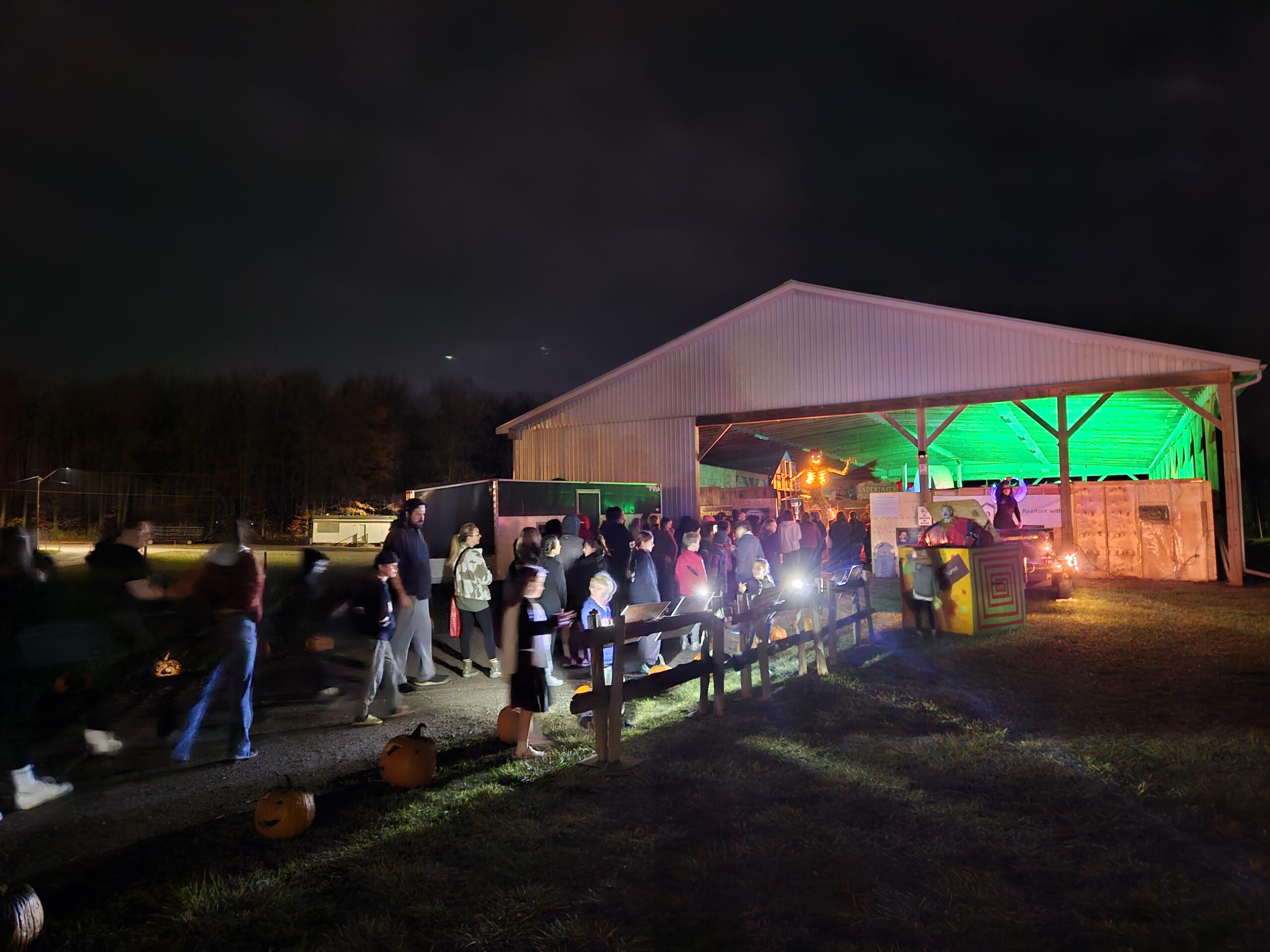 people lined up to enter the haunted house at fiddle park