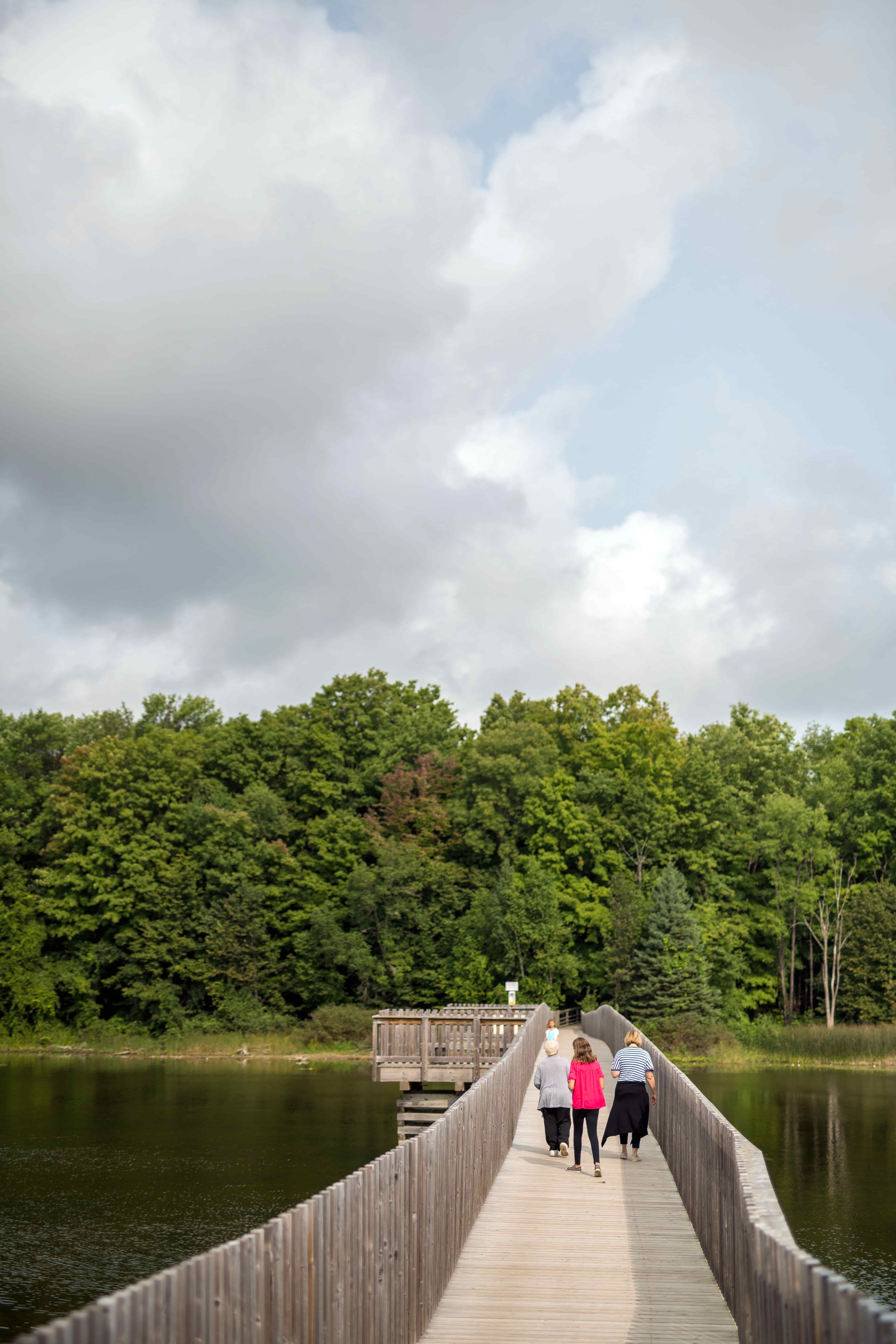 People hiking on Island lake boardwalk.